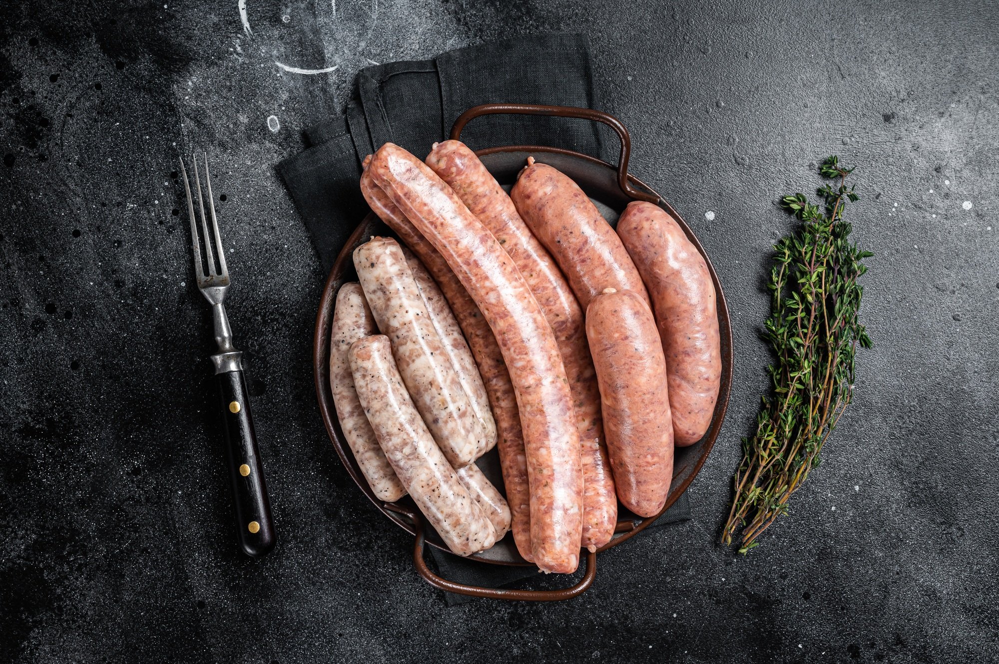 Sausages variation in steel tray. Raw Sausages with Beef, pork, lamb and chicken meat.